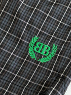 Green Balenciaga BR logo patch on dark plaid shorts