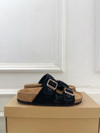 Monogram sandals with black crossover straps and silver buckles, tan footbed