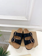 Monogram sandals with two black straps and silver buckles, tan footbed