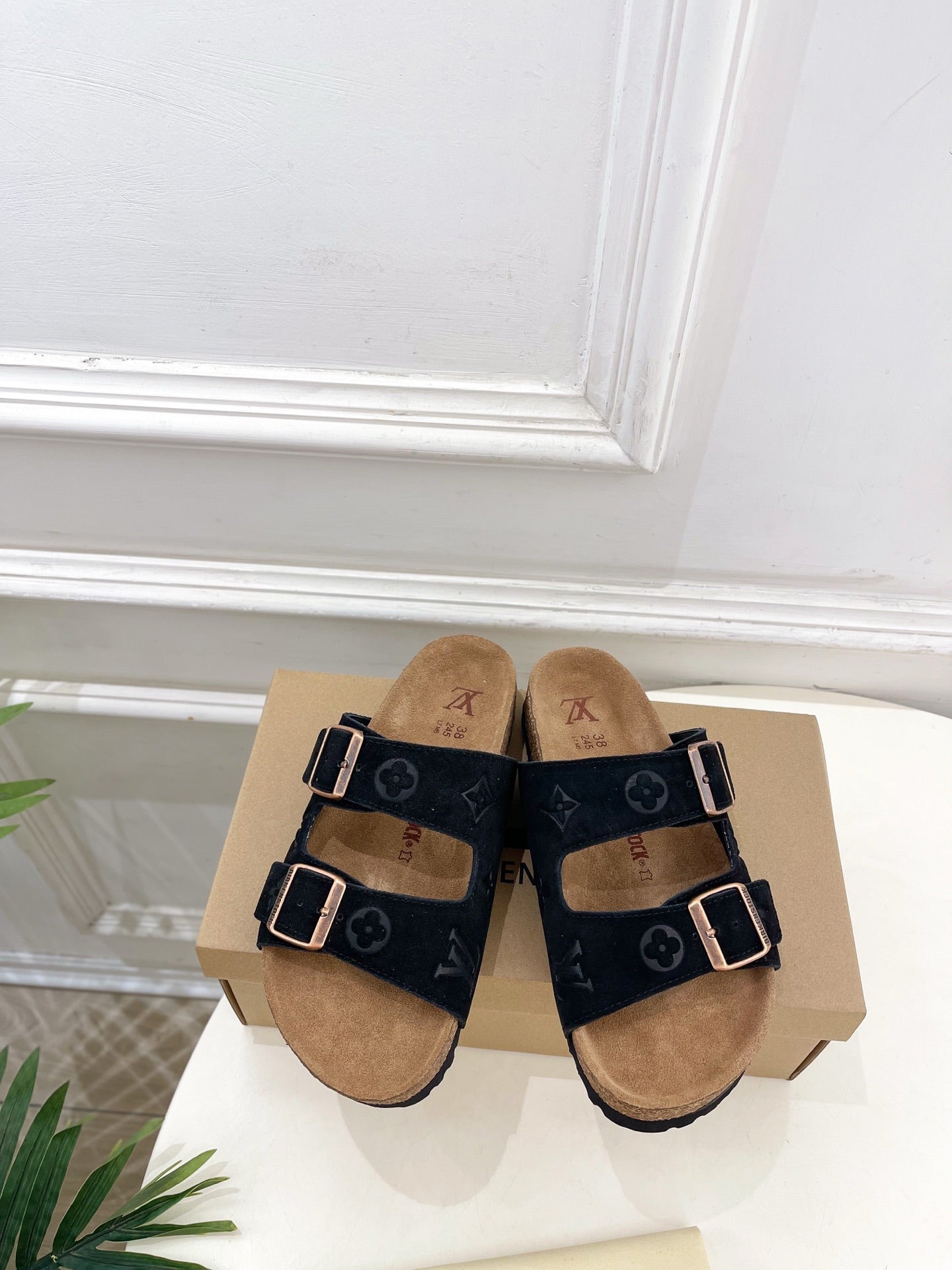 Monogram sandals with two black straps and silver buckles, tan footbed