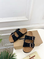 Monogram sandals with black cross straps and silver buckles, tan footbeds