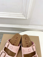 Louis Vuitton sandals with pale pink upper and monogram straps, featuring two metal buckles