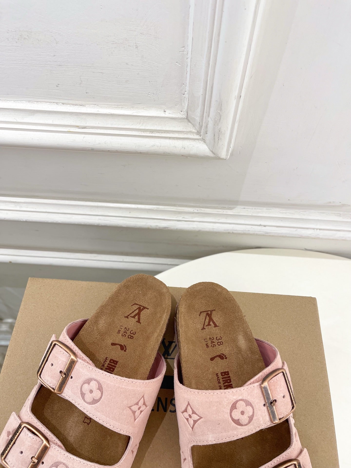 Louis Vuitton sandals with pale pink upper and monogram straps, featuring two metal buckles