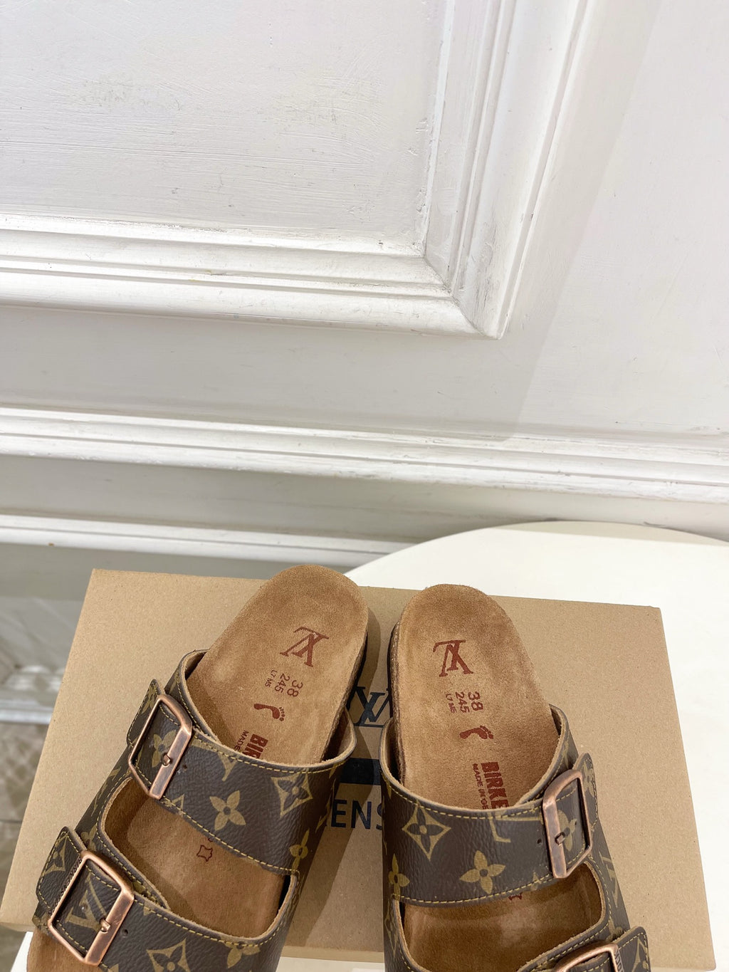 Brown monogram sandals with two buckle straps and tan branded footbed