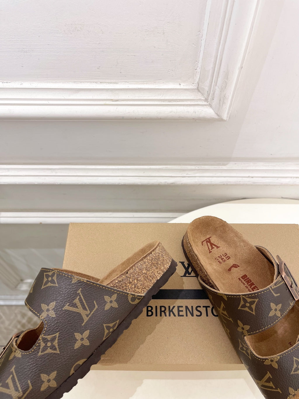 Brown monogram slide sandals with glittery strap accent and two buckles