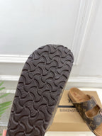 Dark textured rubber sandal outsole with molded grip pattern