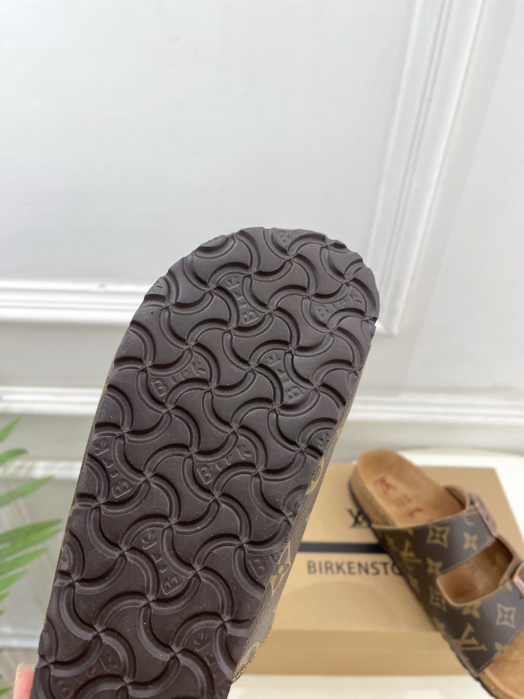Black textured rubber sandal outsole with circular embossed pattern
