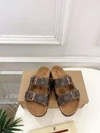 Brown monogram slide sandals with two silver buckles and tan footbed