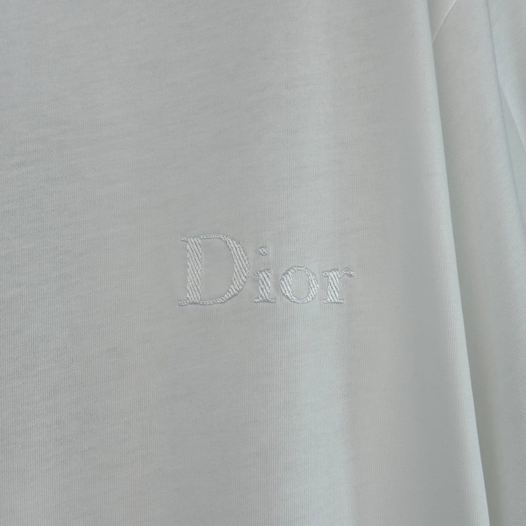 White Dior T-shirt with embossed 'Dior' logo on chest.