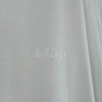 White Dior T-shirt with embossed 'Dior' logo on chest.