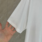 White Dior T-shirt with short sleeve and clean hem finish.