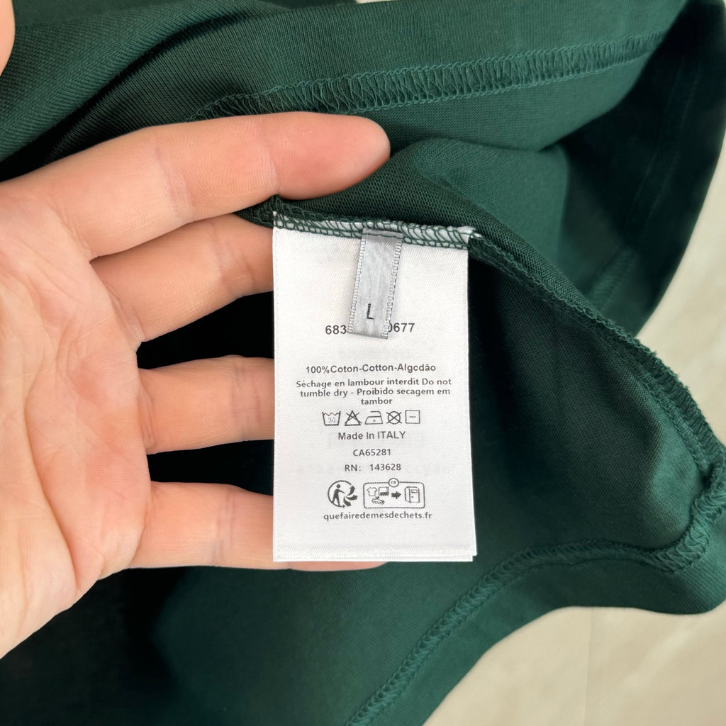 Inside collar care label on dark green T-shirt