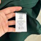 Inside collar care label on dark green T-shirt