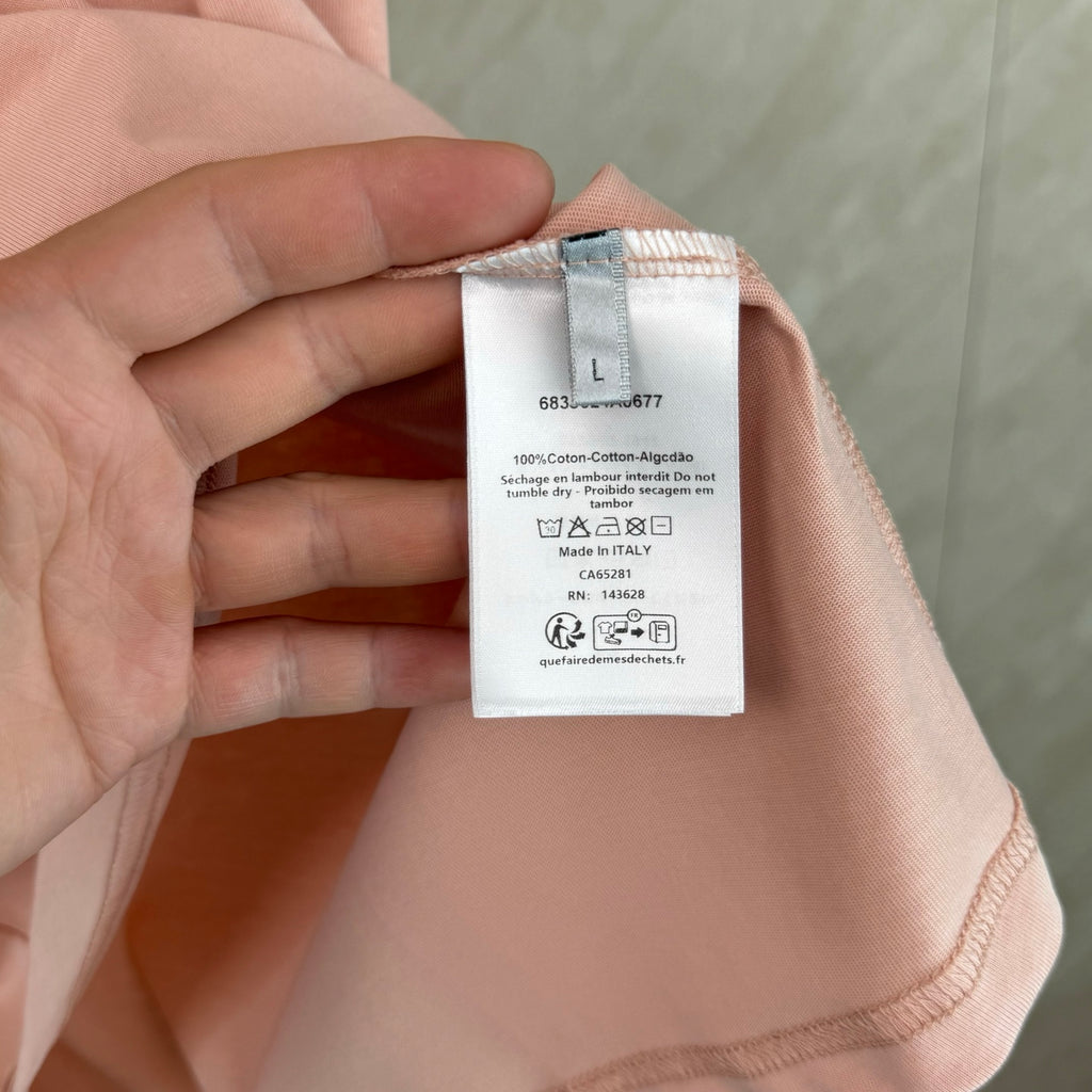 Pink T-shirt fabric care label with cotton content