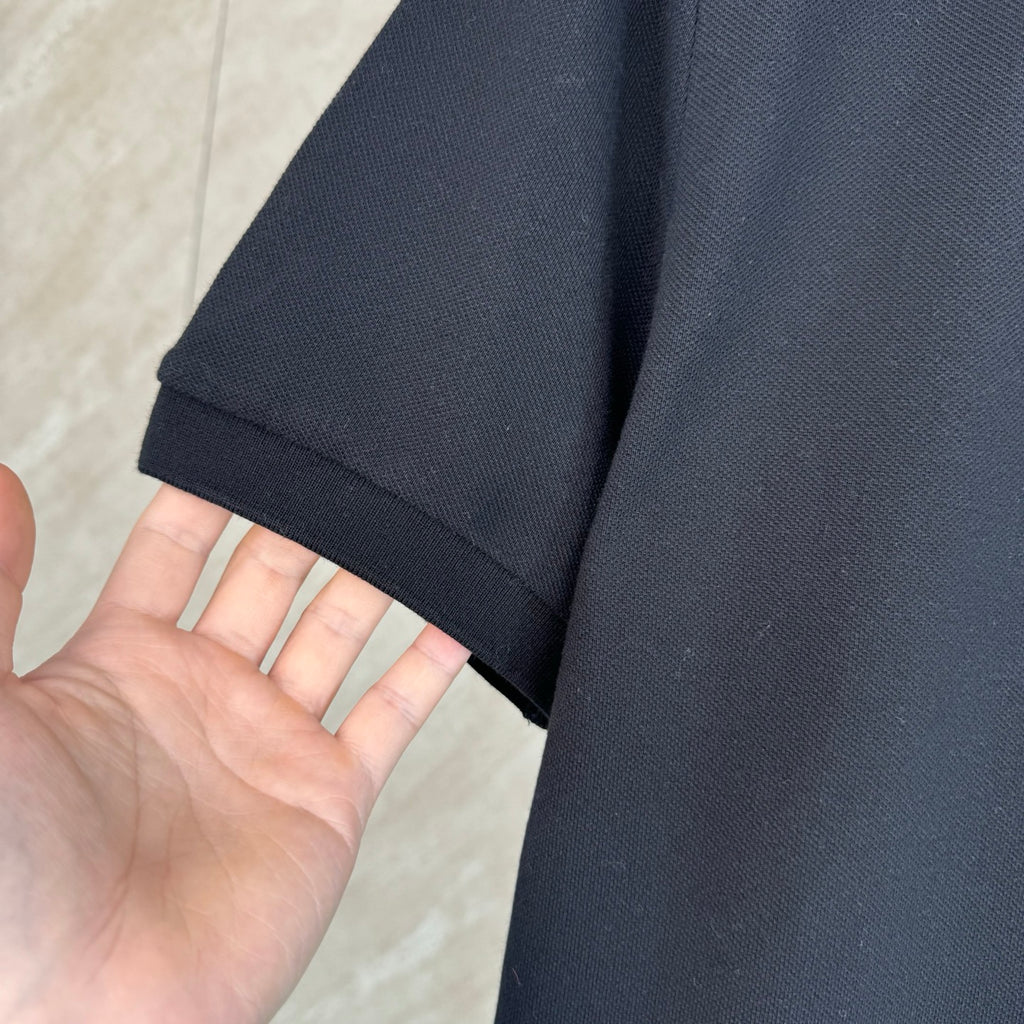 Moncler polo shirt sleeve in dark navy fabric texture, short cuff hem