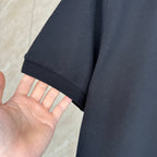 Moncler polo shirt sleeve in dark navy fabric texture, short cuff hem