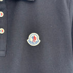 Moncler logo patch on dark navy polo shirt placket area