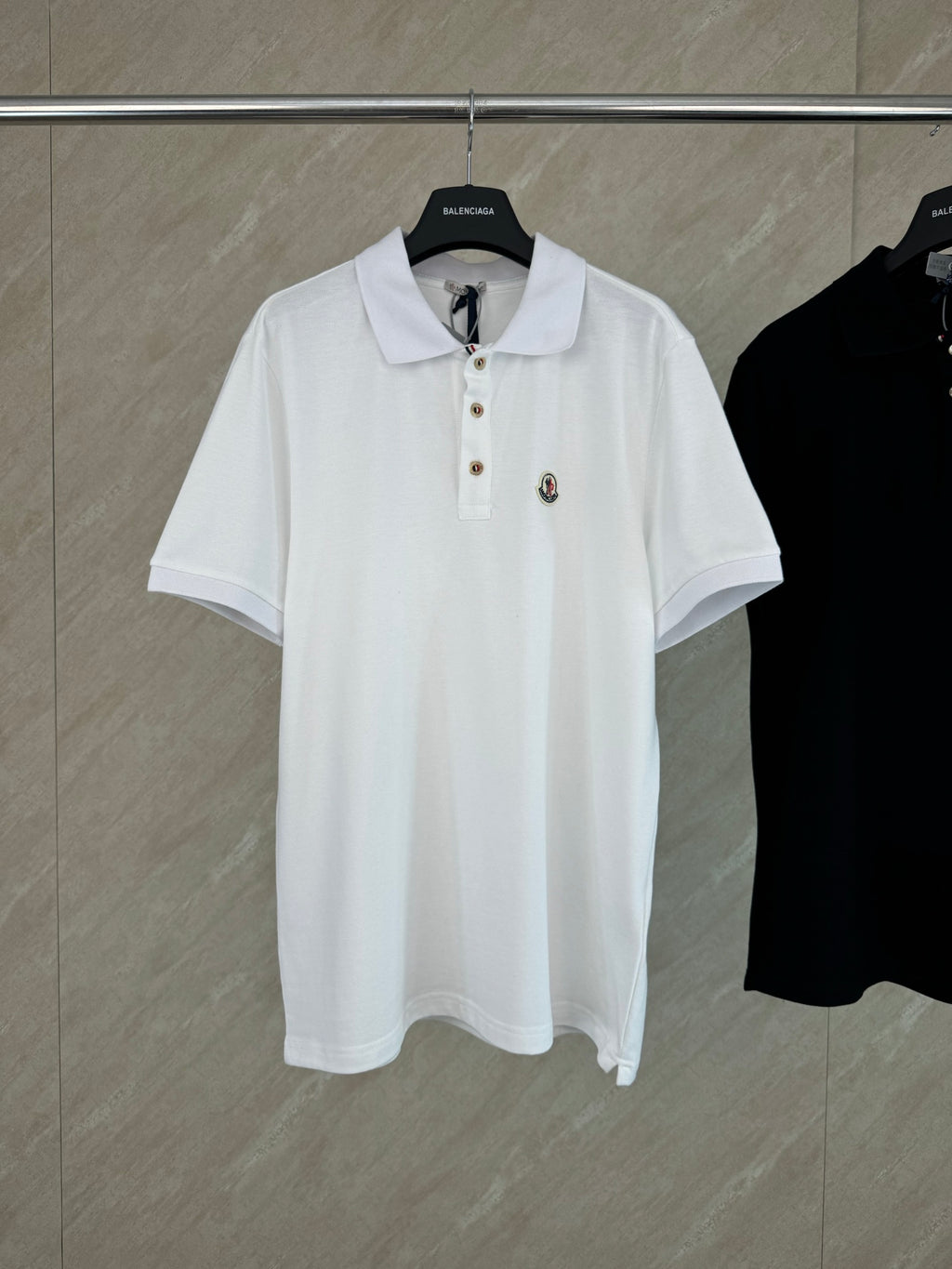 White short-sleeve polo shirt with button placket and chest logo