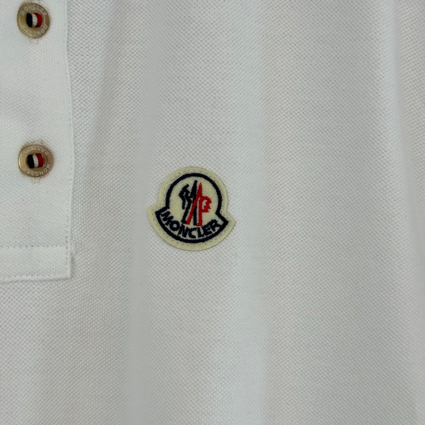 White polo shirt chest patch with crest emblem