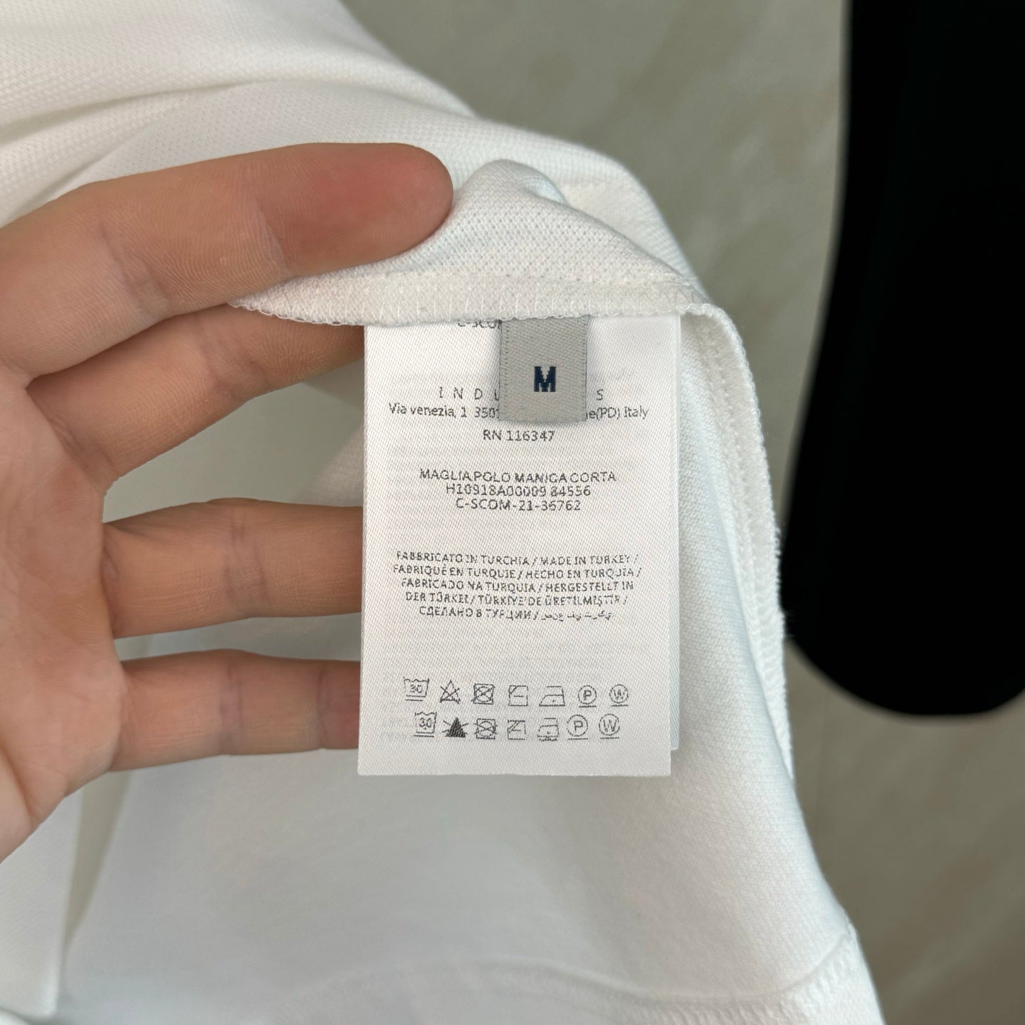 Light garment size label on white fabric, inner tag on shorts