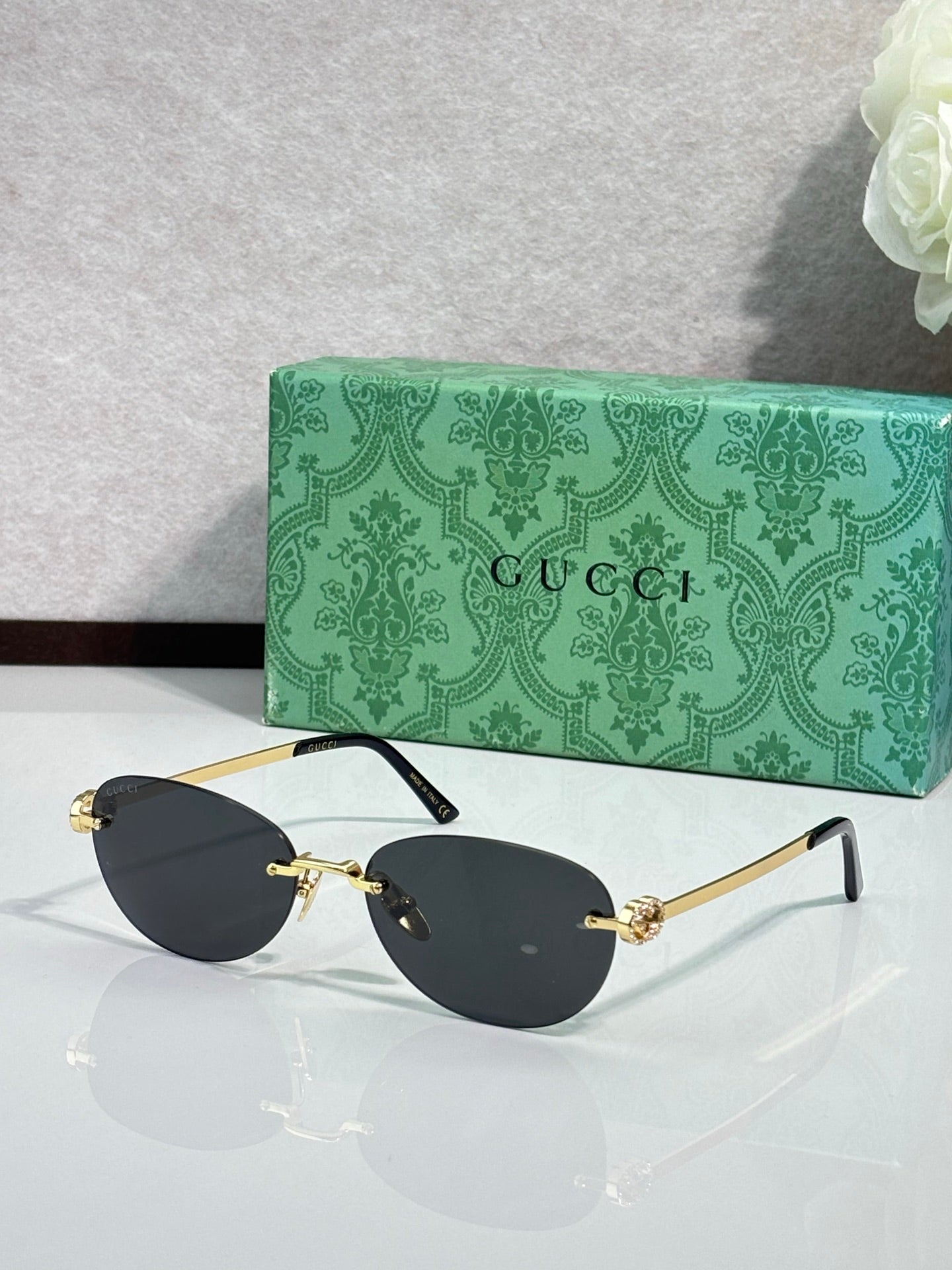 Gucci cat-eye sunglasses with black lenses and gold-tone arms