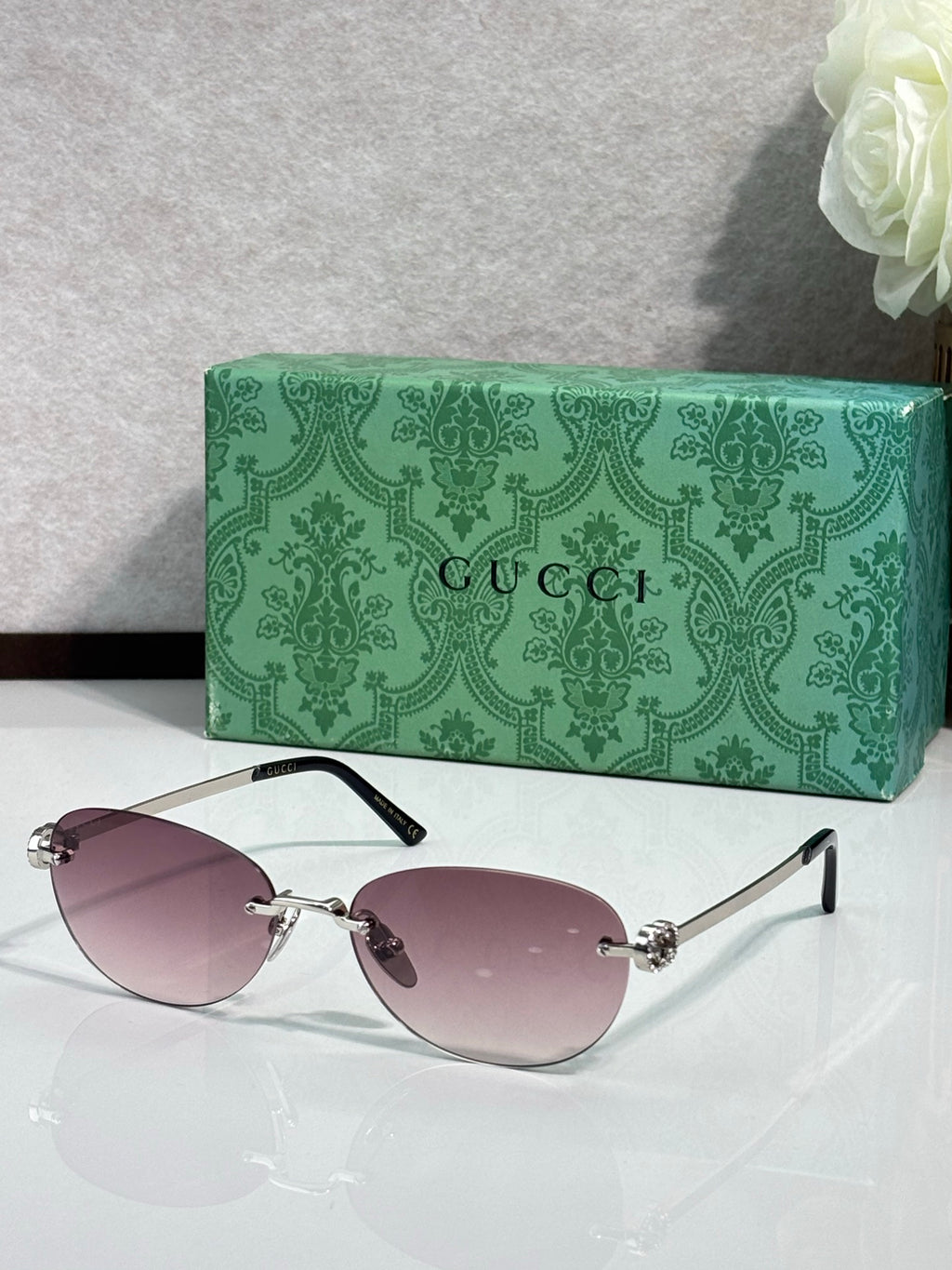 Gucci cat-eye sunglasses with soft pink lenses and silver-tone metal arms