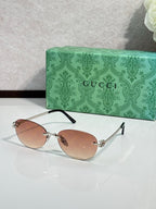 Gucci cat-eye sunglasses with rose-brown lenses and silver-tone frame