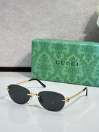 Gucci cat-eye sunglasses with black lenses and gold-tone metal details