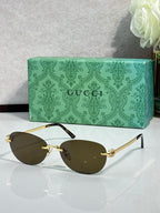 Gucci cat-eye sunglasses with dark lenses and gold-tone metal arms