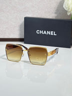 Gold-rim square sunglasses with amber gradient lenses, CHANEL branding on case
