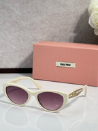 MiuMiu sunglasses with cream frames and purple tinted lenses