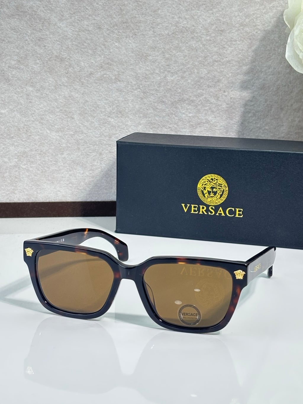 Versace sunglasses with dark blue/black frames and brown tinted lenses
