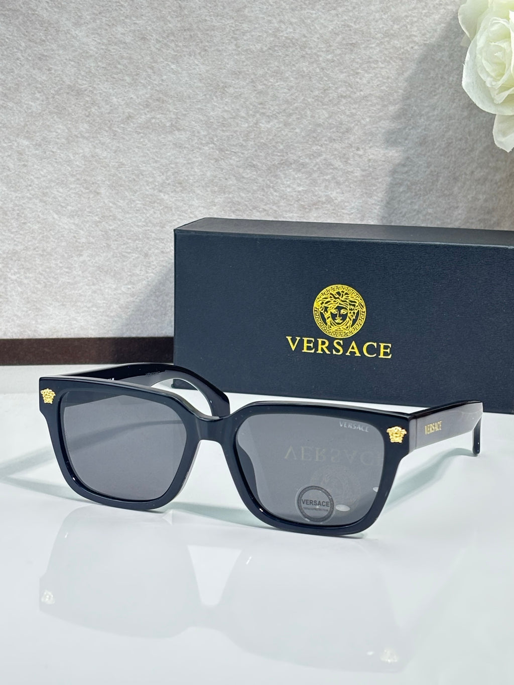 Versace sunglasses with dark blue/black square frames and gray tinted lenses