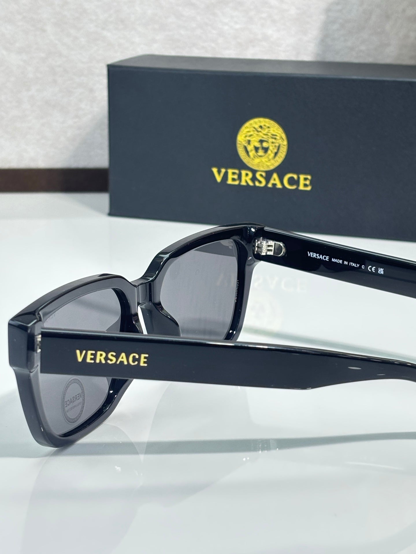 Versace sunglasses with dark blue/black frames and dark gray tinted lenses