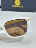 Versace sunglasses close-up with white frames and brown tinted lenses