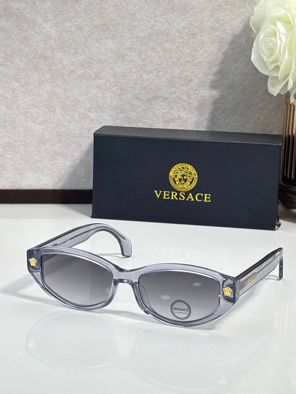 Versace sunglasses with dark blue-gray frame and gray tinted lenses