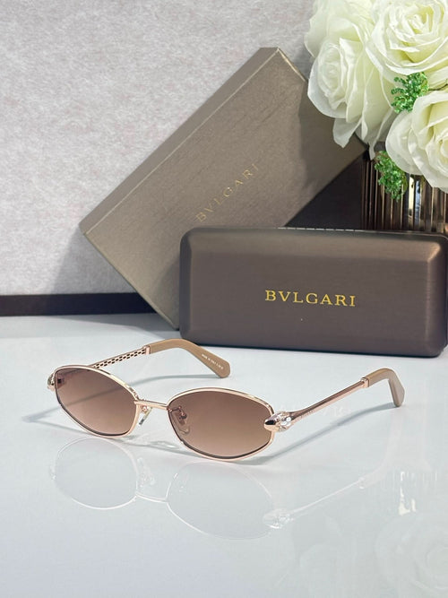 Rose-gold oval sunglasses with tinted lenses and slender metal temple arms