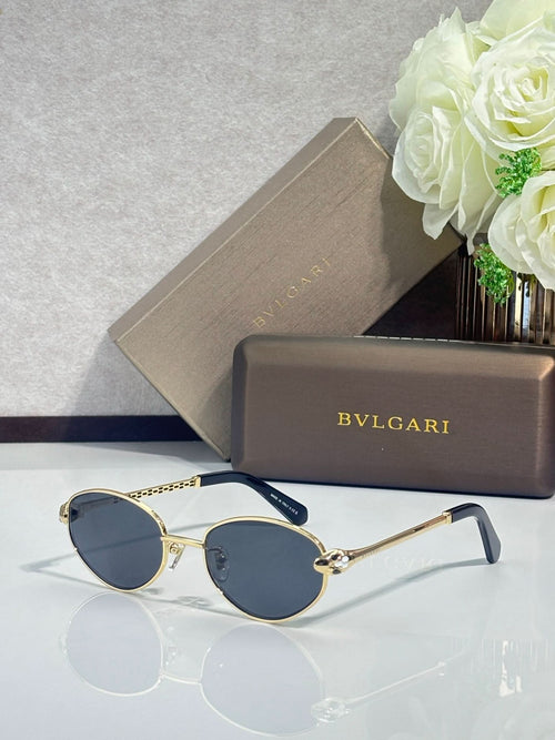 Bvlgari glasses with gold round frames, dark blue lenses, and navy temple tips