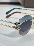 Bvlgari glasses with gold round frames, blue gradient lenses, and patterned bridge