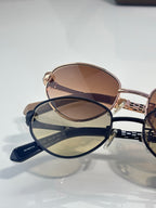 Round sunglasses: one rose-gold with brown lenses, one navy with blue lenses
