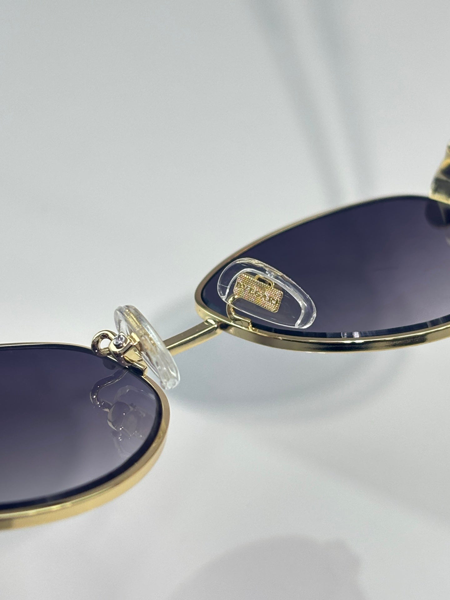 Bvlgari glasses with dark blue gradient lens and gold temple hinge