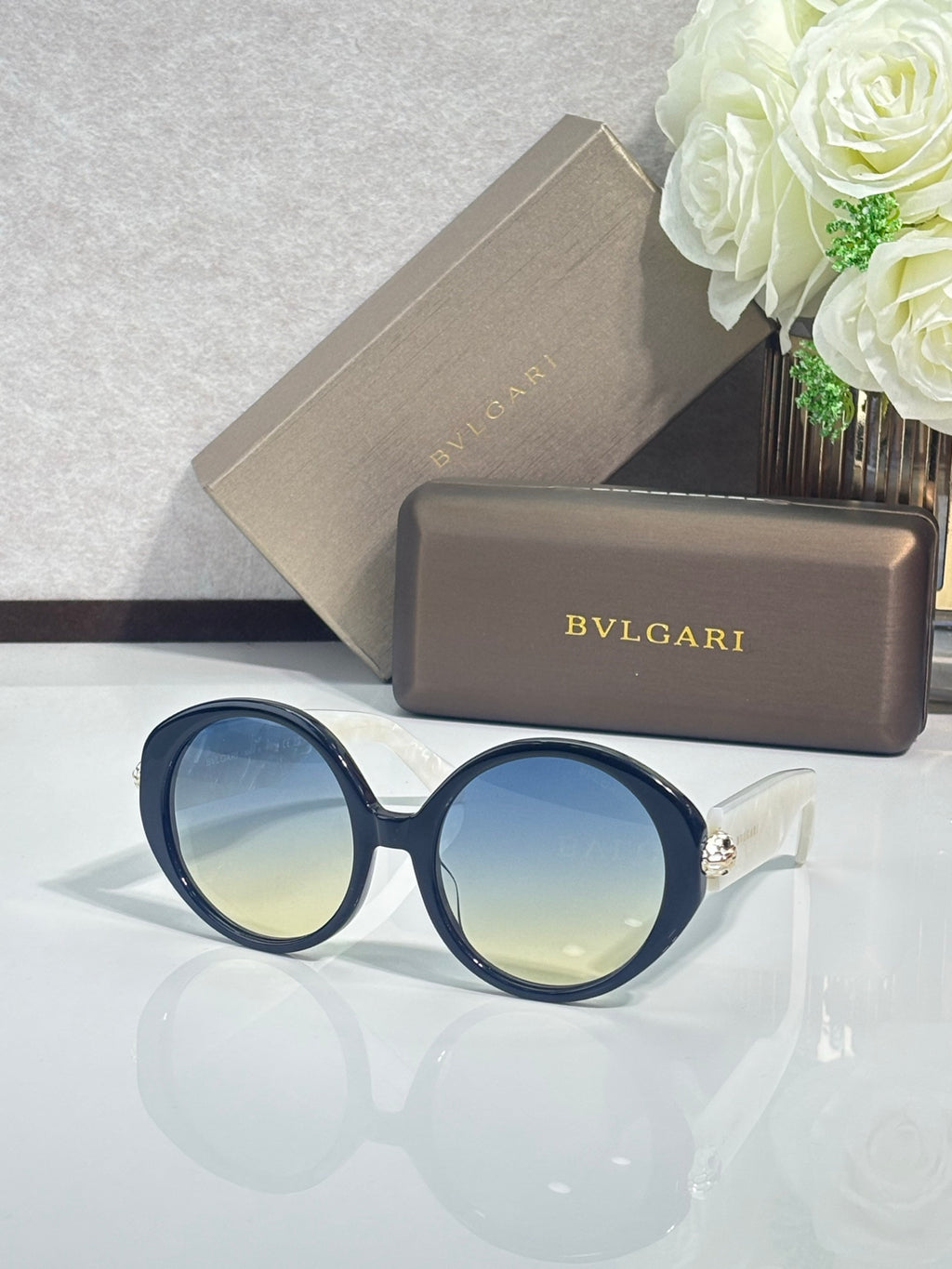 Round sunglasses with dark blue frames and blue-tinted lenses