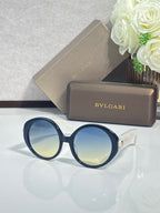 Round sunglasses with dark blue frames and blue-tinted lenses