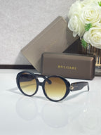 Round sunglasses with dark blue frames and yellow-tinted lenses