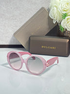 Round sunglasses with pink frames and light tan-tinted lenses