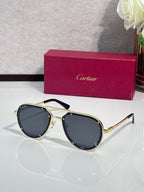 Cartier sunglasses with gold frame and dark blue lenses, cat-eye shape