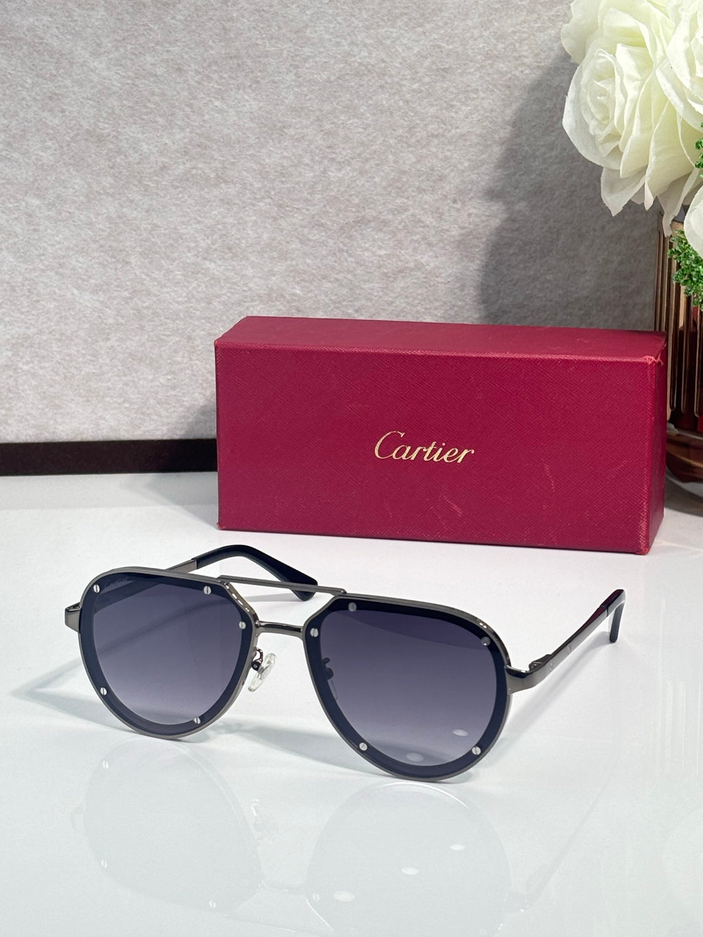 Cartier sunglasses with gold frame and dark blue lenses, cat-eye silhouette