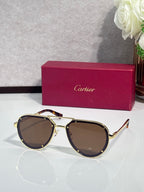 Cartier sunglasses with gold frame and brown lenses, cat-eye shape