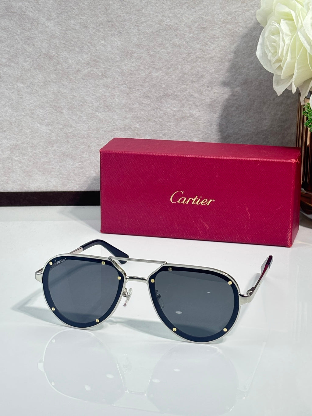 Cartier sunglasses with navy-and-gold frame and dark blue lenses, front view