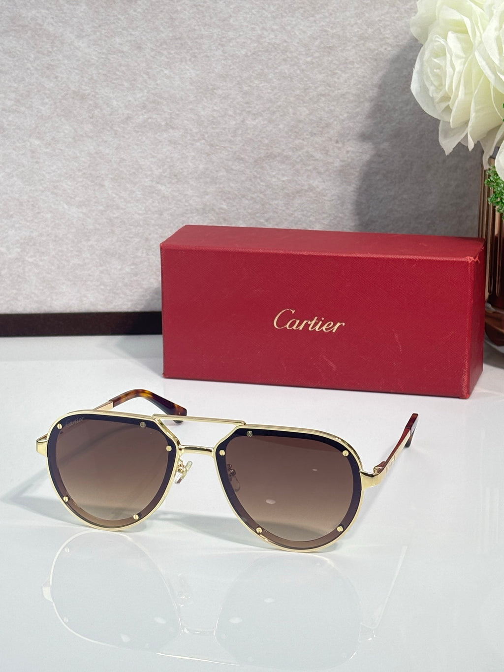 Cartier sunglasses with gold frame and brown lenses, cat-eye silhouette